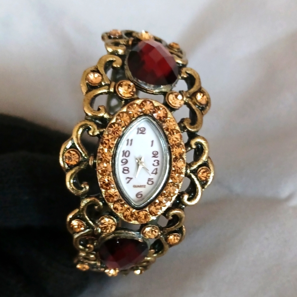 Victorian Era Type design brass colored bangle watch timepiece red brown stones